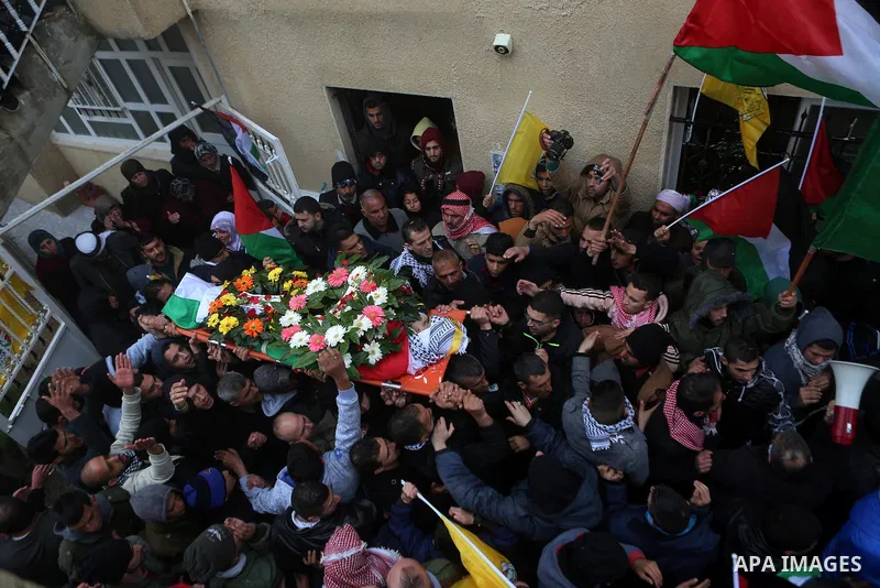 Palestinian mourners carry the body of one of two Palestinians, who the Israeli military said were fatally shot by Israeli police officers after they opened fire at them outside Jerusalem's walled Old City on February 14...