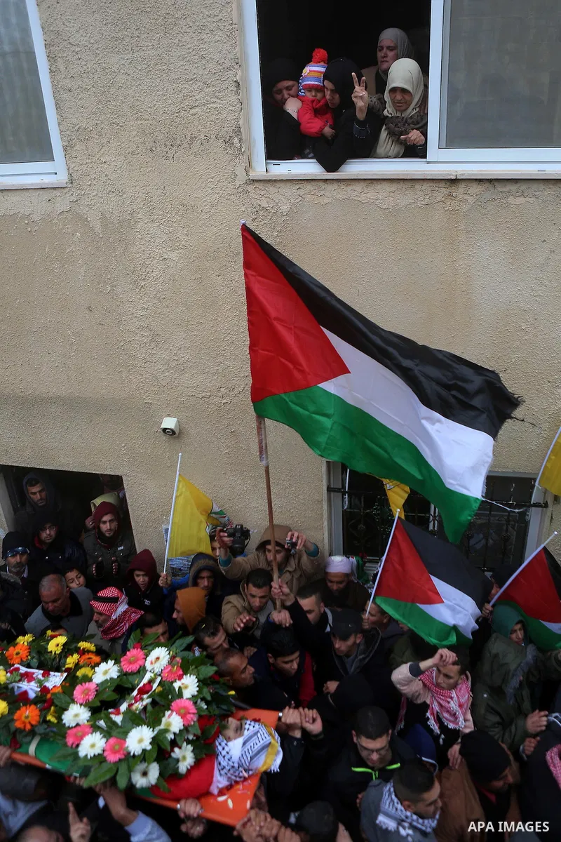 Palestinian mourners carry the body of one of two Palestinians, who the Israeli military said were fatally shot by Israeli police officers after they opened fire at them outside Jerusalem's walled Old City on February 14...