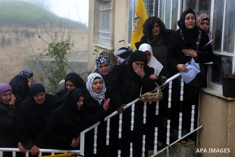 Palestinian mourners carry the body of one of two Palestinians, who the Israeli military said were fatally shot by Israeli police officers after they opened fire at them outside Jerusalem's walled Old City on February 14...