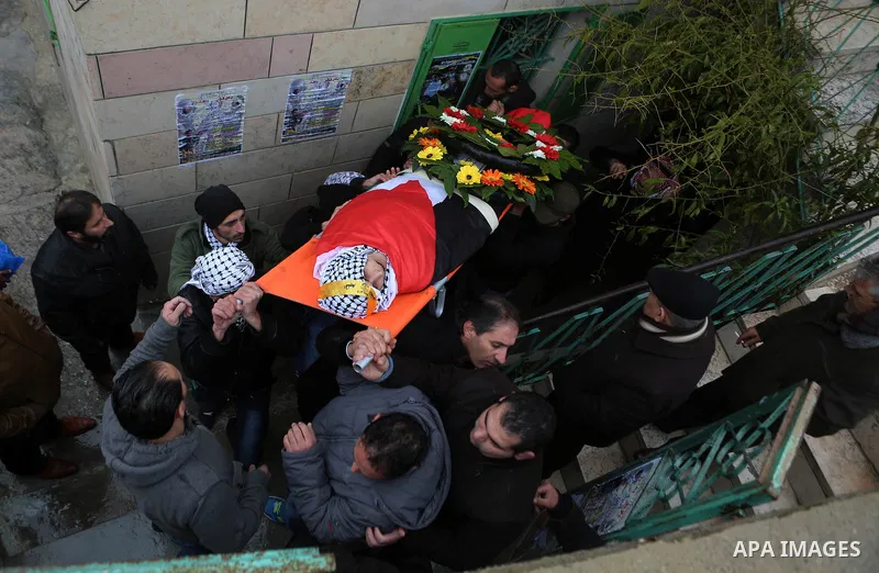 Palestinian mourners carry the body of one of two Palestinians, who the Israeli military said were fatally shot by Israeli police officers after they opened fire at them outside Jerusalem's walled Old City on February 14...