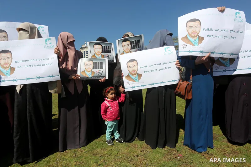Palestinian students hold posters bearing a portrait of Palestinian journalist Mohammed al-Qiq who is imprisoned in an Israeli jail during a protest in support of his hunger strike, in Gaza city, on Feb. 24, 2016. Photo...