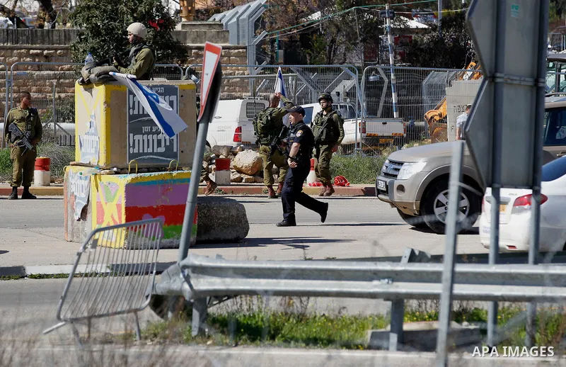 Israeli soldiers gather at the scene of an attack at the Gush Etzion junction in the West Bank, Wednesday, Feb. 24, 2016. The Israeli military says a knife-wielding Palestinian rushed toward an Israeli in the West Bank a...