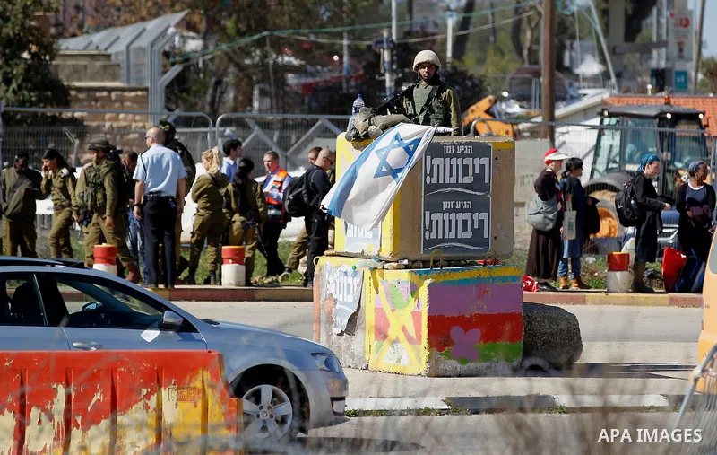 Israeli soldiers gather at the scene of an attack at the Gush Etzion junction in the West Bank, Wednesday, Feb. 24, 2016. The Israeli military says a knife-wielding Palestinian rushed toward an Israeli in the West Bank a...