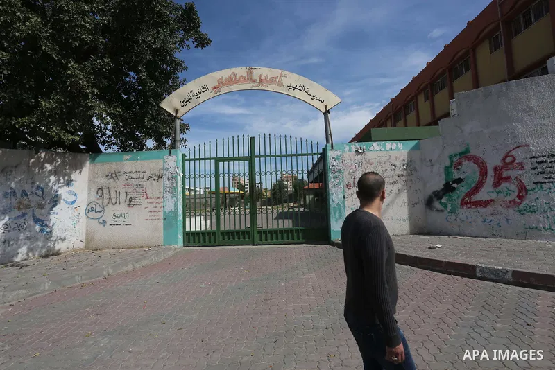 A Palestinian man walks past a closed school during the strike of the employees of former Palestinian government in Gaza Strip and West bank to demand for pay their salaries, in Gaza city on February 25, 2016. Photo by M...