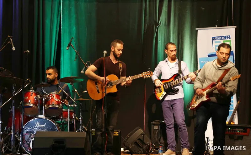 Members of Watar band, Palestinian musical troupe perform during a singing ceremony in Gaza city on Feb. 25, 2016. Photo by Mohammed Asad