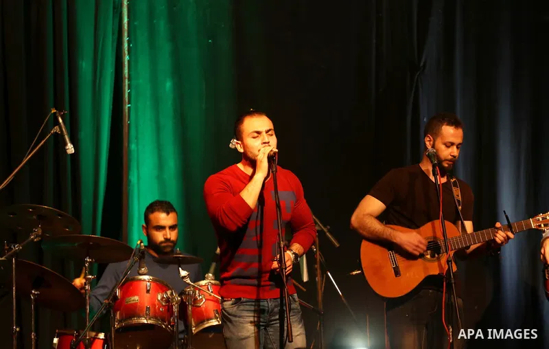 Members of Watar band, Palestinian musical troupe perform during a singing ceremony in Gaza city on Feb. 25, 2016. Photo by Mohammed Asad