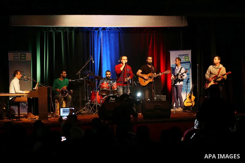 Members of Watar band, Palestinian musical troupe perform during a singing ceremony in Gaza city on Feb. 25, 2016. Photo by Mohammed Asad