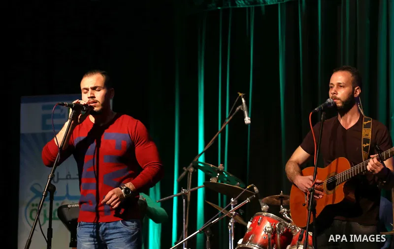 Members of Watar band, Palestinian musical troupe perform during a singing ceremony in Gaza city on Feb. 25, 2016. Photo by Mohammed Asad