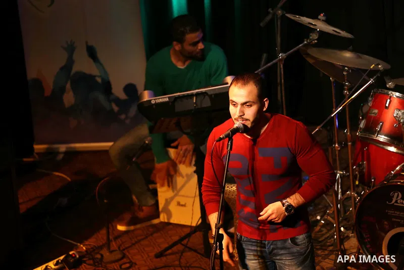 Members of Watar band, Palestinian musical troupe perform during a singing ceremony in Gaza city on Feb. 25, 2016. Photo by Mohammed Asad