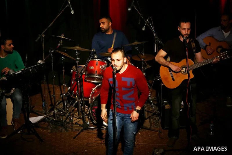 Members of Watar band, Palestinian musical troupe perform during a singing ceremony in Gaza city on Feb. 25, 2016. Photo by Mohammed Asad