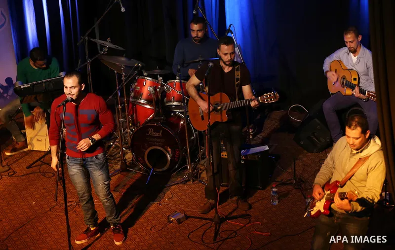 Members of Watar band, Palestinian musical troupe perform during a singing ceremony in Gaza city on Feb. 25, 2016. Photo by Mohammed Asad