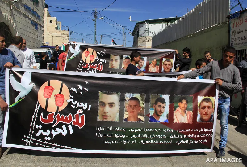 Palestinians take part in a protest to show solidarity with Mohammed al-Qiq a Palestinian hunger strike journalist, who is imprisoned in an Israeli jail, on February 26, 2016 in Jerusalem. Imprisoned Palestinian hunger-s...