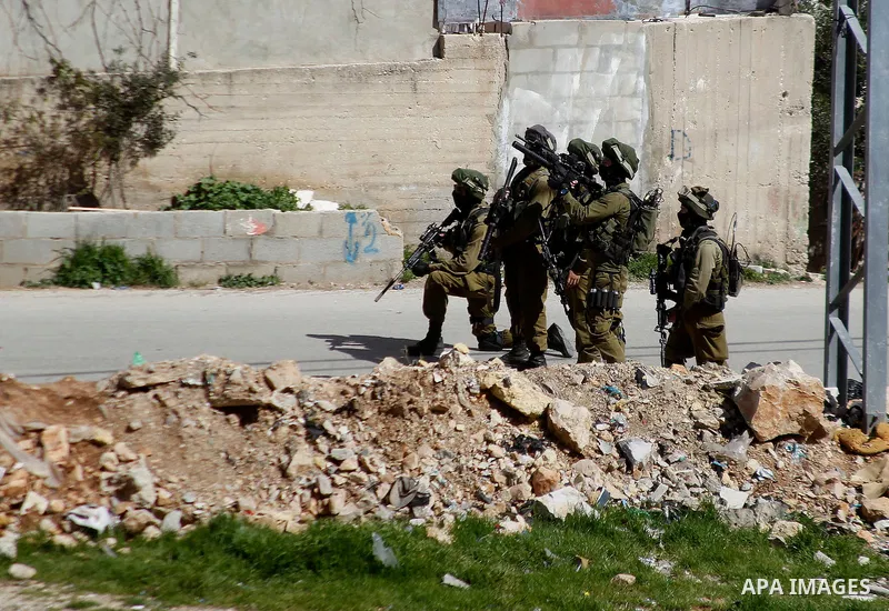 Israeli security forces take position during a demonstration against the closure of Shuhada street to Palestinians, on the 22nd anniversary of the closure, in the West Bank city of Hebron February 26, 2016. Photo by Wisa...