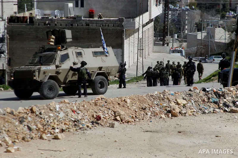 Israeli security forces take position during a demonstration against the closure of Shuhada street to Palestinians, on the 22nd anniversary of the closure, in the West Bank city of Hebron February 26, 2016. Photo by Wisa...