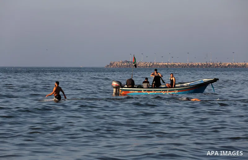 Palestinians enjoy their time at the beach of Gaza city during sunset on Feb. 26, 2016. Photo by Mohammed Asad