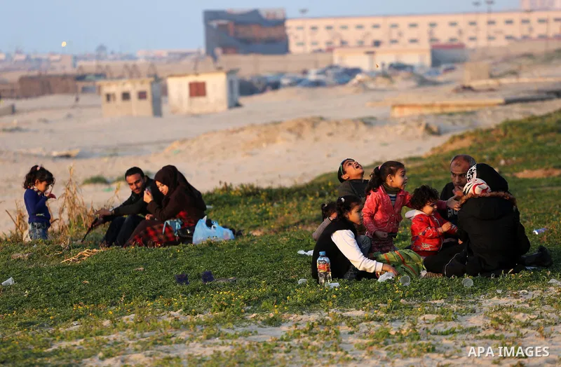 Palestinians enjoy their time at the beach of Gaza city during sunset on Feb. 26, 2016. Photo by Mohammed Asad