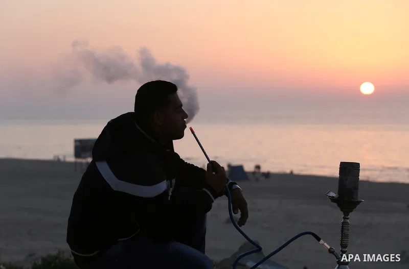 Palestinians enjoy their time at the beach of Gaza city during sunset on Feb. 26, 2016. Photo by Mohammed Asad