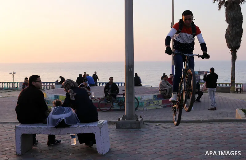 Palestinians enjoy their time at the beach of Gaza city during sunset on Feb. 26, 2016. Photo by Mohammed Asad
