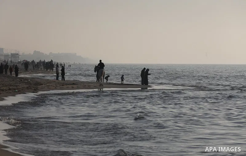 Palestinians enjoy their time at the beach of Gaza city during sunset on Feb. 26, 2016. Photo by Mohammed Asad