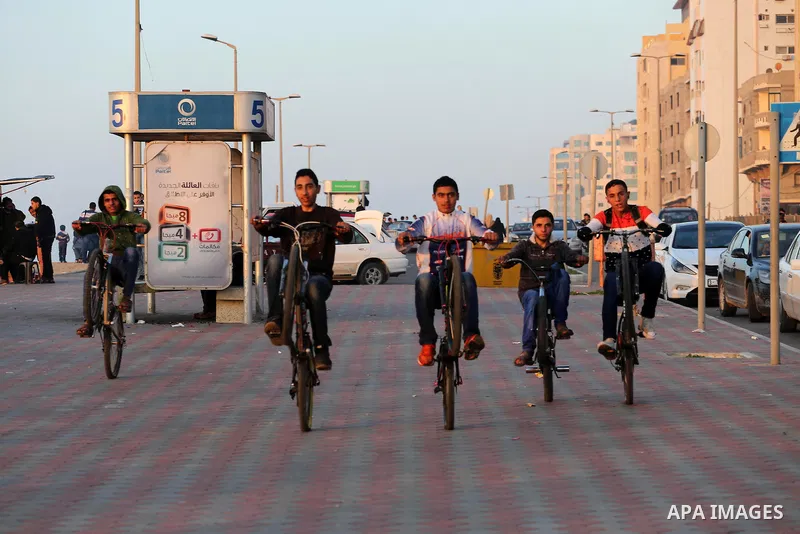 Palestinians enjoy their time at the beach of Gaza city during sunset on Feb. 26, 2016. Photo by Mohammed Asad
