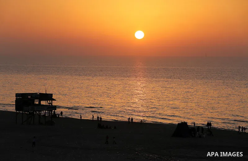 Palestinians enjoy their time at the beach of Gaza city during sunset on Feb. 26, 2016. Photo by Mohammed Asad