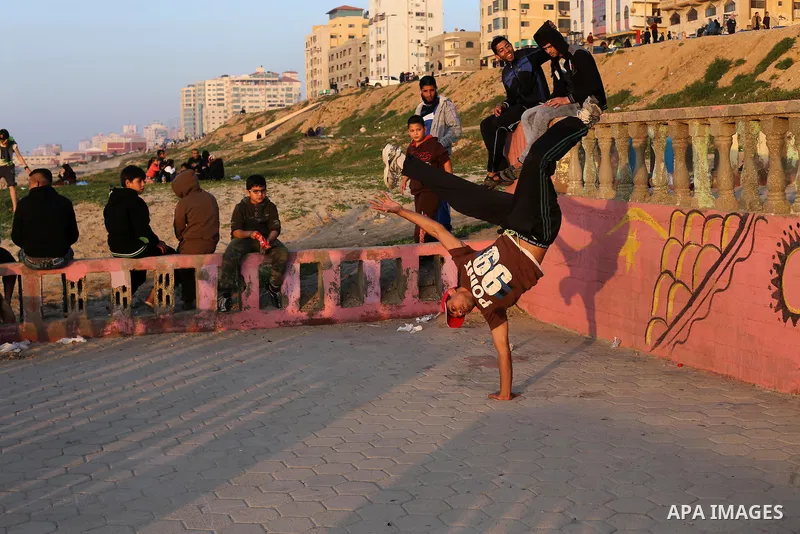 Palestinians enjoy their time at the beach of Gaza city during sunset on Feb. 26, 2016. Photo by Mohammed Asad