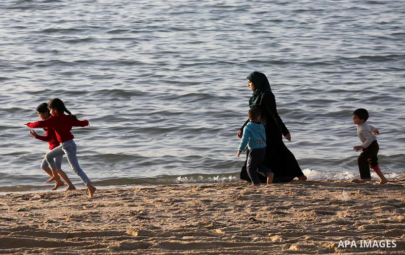 Palestinians enjoy their time at the beach of Gaza city during sunset on Feb. 26, 2016. Photo by Mohammed Asad