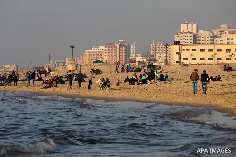 Palestinians enjoy their time at the beach of Gaza city during sunset on Feb. 26, 2016. Photo by Mohammed Asad