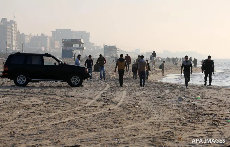 Palestinians enjoy their time at the beach of Gaza city during sunset on Feb. 26, 2016. Photo by Mohammed Asad