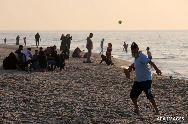 Palestinians enjoy their time at the beach of Gaza city during sunset on Feb. 26, 2016. Photo by Mohammed Asad