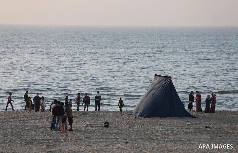 Palestinians enjoy their time at the beach of Gaza city during sunset on Feb. 26, 2016. Photo by Mohammed Asad