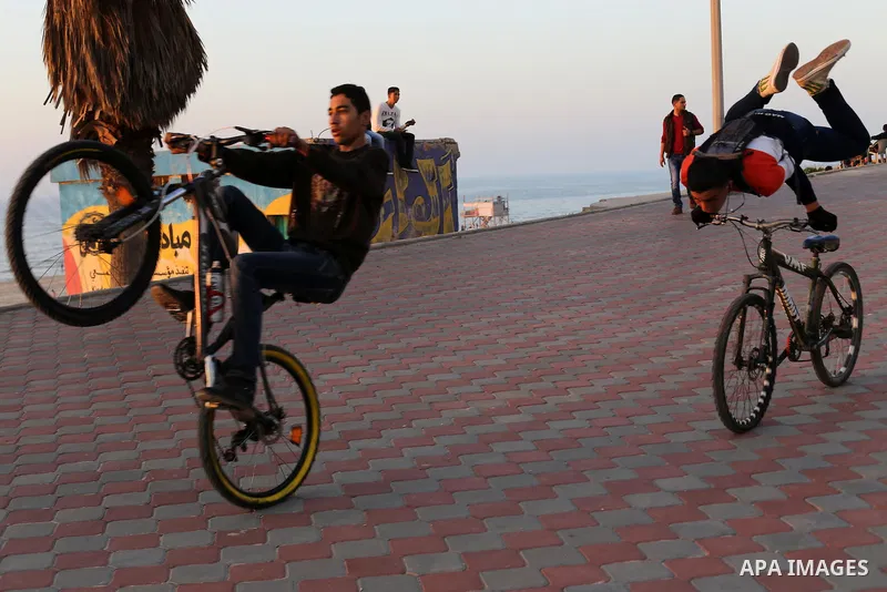 Palestinians enjoy their time at the beach of Gaza city during sunset on Feb. 26, 2016. Photo by Mohammed Asad
