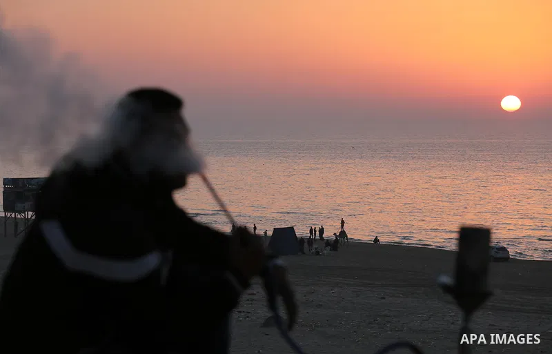 Palestinians enjoy their time at the beach of Gaza city during sunset on Feb. 26, 2016. Photo by Mohammed Asad