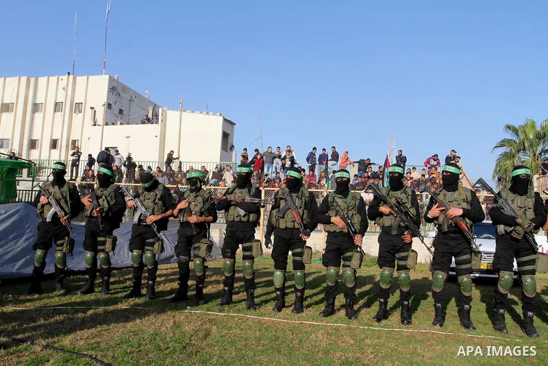 Palestinian militants of the Ezzedine al-Qassam Brigades, the armed wing of the Hamas movement, take part in an anti-Israel rally on February 26, 2016, in the southern Gaza Strip town of Rafah. Photo by Abed Rahim Khatib