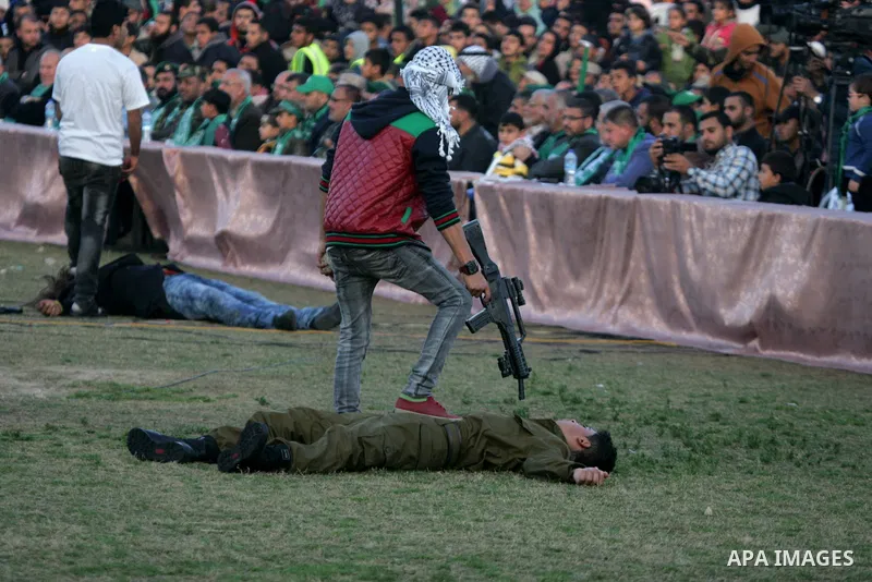 Palestinian boys simulate an attack during a show as part of an anti-Israel rally on February 26, 2016, in the southern Gaza Strip town of Rafah. Photo by Abed Rahim Khatib