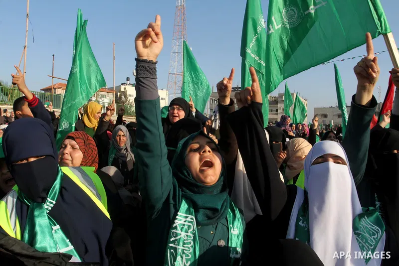 Palestinian supporters of the Hamas islamist movement shout slogans during an anti-Israel rally on February 26, 2016, in the southern Gaza Strip town of Rafah. Photo by Abed Rahim Khatib