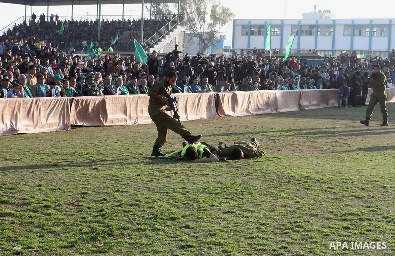 Palestinian boys simulate an attack during a show as part of an anti-Israel rally on February 26, 2016, in the southern Gaza Strip town of Rafah. Photo by Abed Rahim Khatib