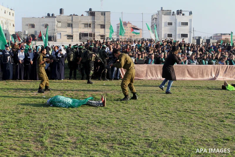 Palestinian boys simulate an attack during a show as part of an anti-Israel rally on February 26, 2016, in the southern Gaza Strip town of Rafah. Photo by Abed Rahim Khatib
