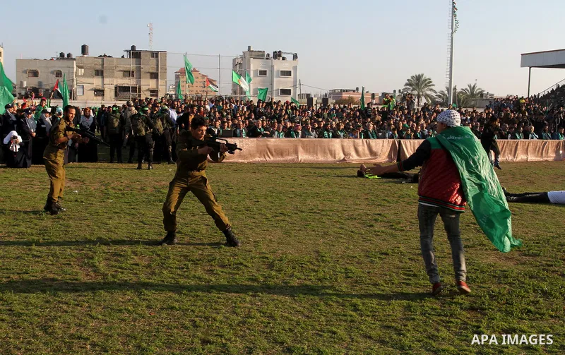 Palestinian boys simulate an attack during a show as part of an anti-Israel rally on February 26, 2016, in the southern Gaza Strip town of Rafah. Photo by Abed Rahim Khatib