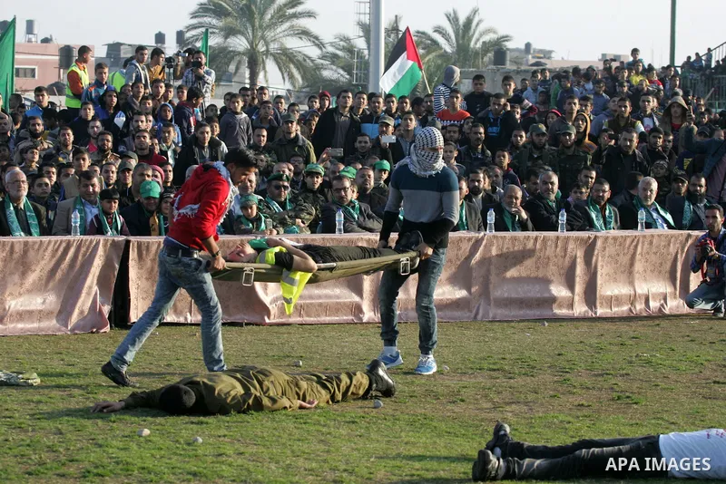 Palestinian boys simulate an attack during a show as part of an anti-Israel rally on February 26, 2016, in the southern Gaza Strip town of Rafah. Photo by Abed Rahim Khatib