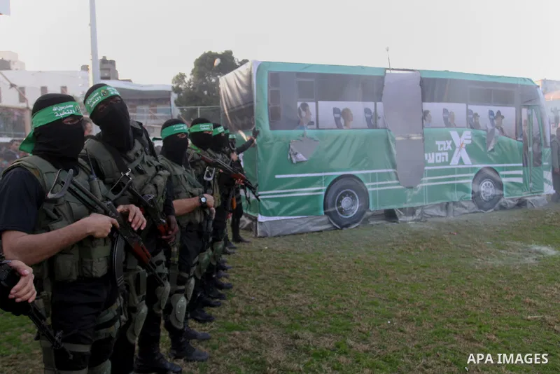 Palestinian militants of the Ezzedine al-Qassam Brigades, the armed wing of the Hamas movement, take part in an anti-Israel rally on February 26, 2016, in the southern Gaza Strip town of Rafah. Photo by Abed Rahim Khatib