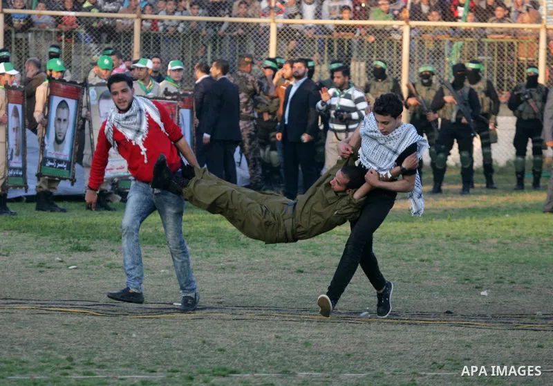 Palestinian boys simulate an attack during a show as part of an anti-Israel rally on February 26, 2016, in the southern Gaza Strip town of Rafah. Photo by Abed Rahim Khatib