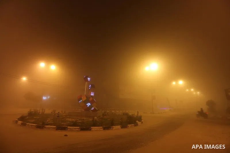 Palestinians walk at a street during foggy weather in Gaza City, The Gaza Strip, 27 February 2016. Photo by Mohammed Asad