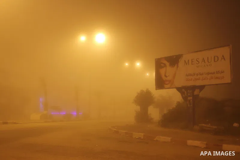 Palestinians walk at a street during foggy weather in Gaza City, The Gaza Strip, 27 February 2016. Photo by Mohammed Asad