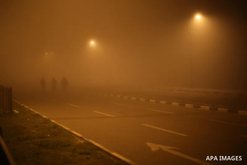 Palestinians walk at a street during foggy weather in Gaza City, The Gaza Strip, 27 February 2016. Photo by Mohammed Asad