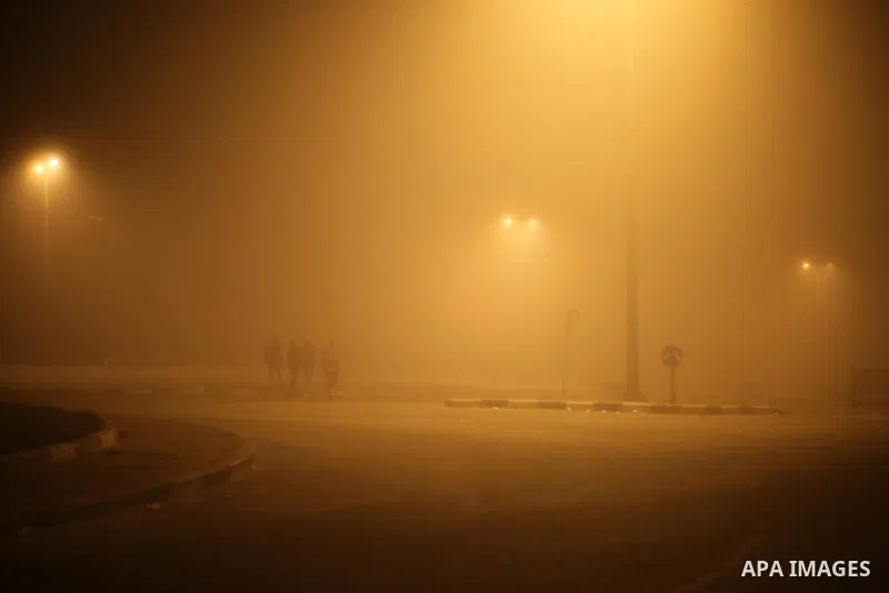 Palestinians walk at a street during foggy weather in Gaza City, The Gaza Strip, 27 February 2016. Photo by Mohammed Asad