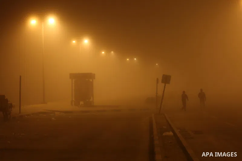 Palestinians walk at a street during foggy weather in Gaza City, The Gaza Strip, 27 February 2016. Photo by Mohammed Asad