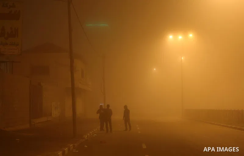 Palestinians walk at a street during foggy weather in Gaza City, The Gaza Strip, 27 February 2016. Photo by Mohammed Asad