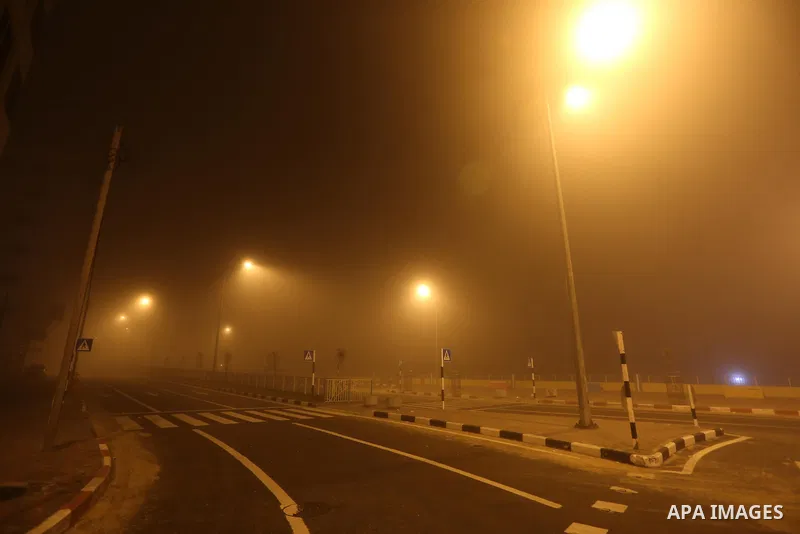 Palestinians walk at a street during foggy weather in Gaza City, The Gaza Strip, 27 February 2016. Photo by Mohammed Asad
