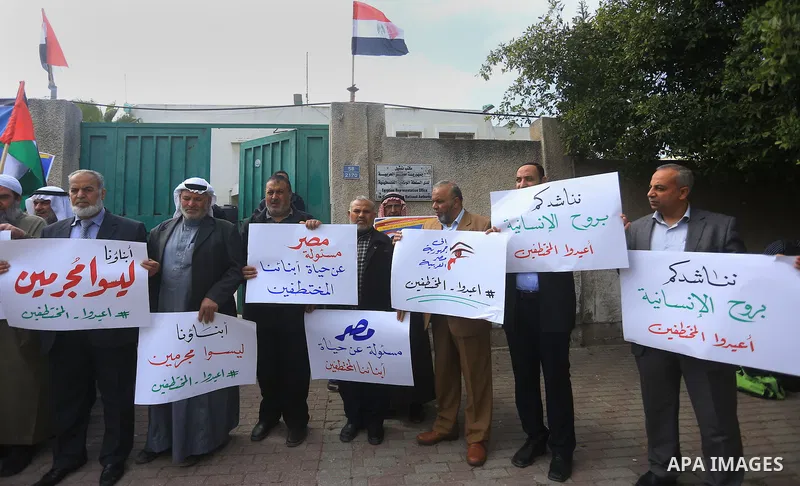Relatives of four Palestinian men abducted by unidentified masked gunmen on August 19, hold their relatives' pictures during a protest demanding for their return, in front of the Egyptian embassy, in Gaza city, on Februa...